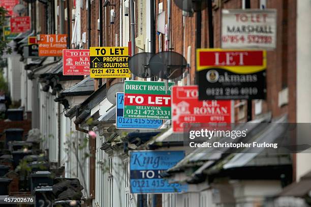 An array of To Let and For Sale signs protrude from houses in the Selly Oak area of Birmingham on October 14, 2014 in Birmingham, United Kingdom. The...