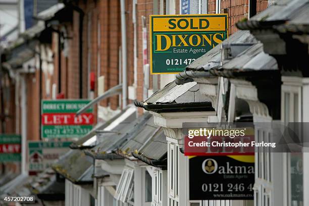 An array of To Let and For Sale signs protrude from houses in the Selly Oak area of Birmingham on October 14, 2014 in Birmingham, United Kingdom. The...