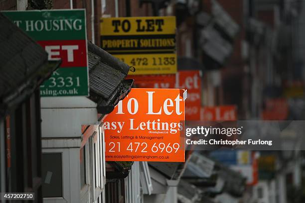 An array of To Let and For Sale signs protrude from houses in the Selly Oak area of Birmingham on October 14, 2014 in Birmingham, United Kingdom. The...