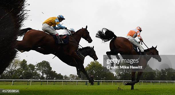 Jamie Moore and Cabimas jump the last ahead of Richard Johnson and Trickaway on their way to victory in the Weatherbys Hamilton Insurance Novices'...