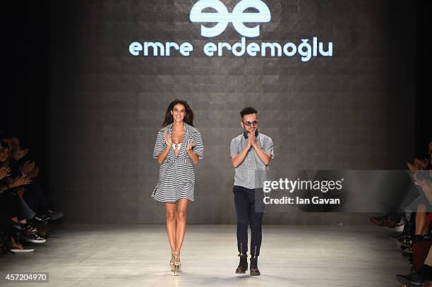 Fashion designer Emre Erdemoglu acknowledges the applause of the audience after the Emre Erdemoglu show during Mercedes Benz Fashion Week Istanbul...