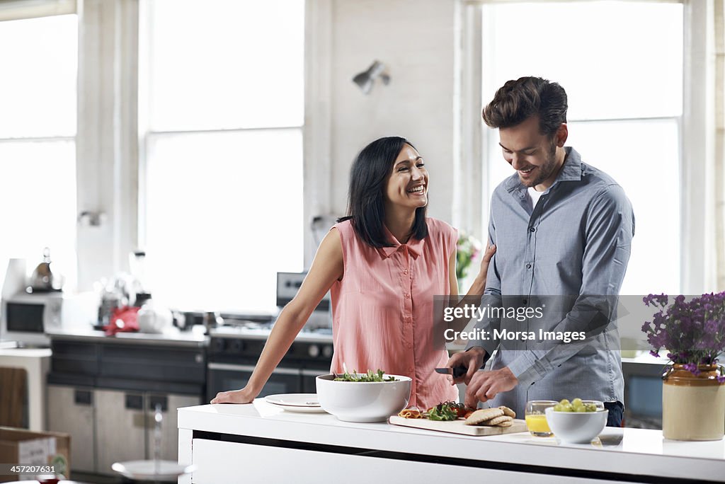 Couple preparing food in kitchen