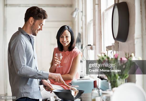 couple cooking together - couple in kitchen stock pictures, royalty-free photos & images