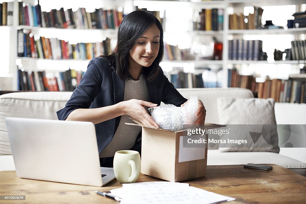 Woman preparing parcel for shipment