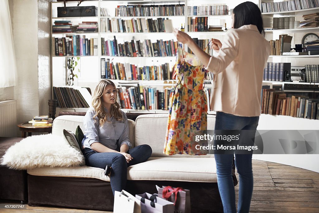 Woman showing a friend her new dress