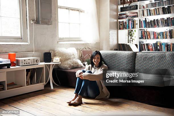 portrait of woman sitting on the floor - sitting on ground stock pictures, royalty-free photos & images