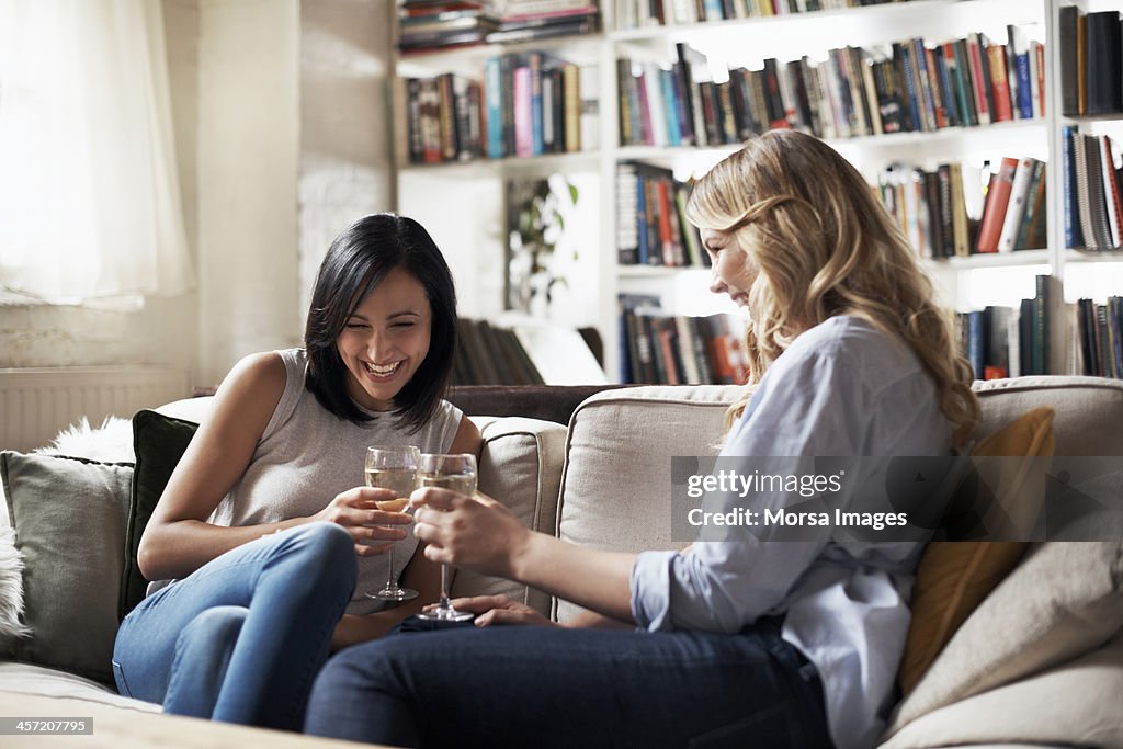 Women sitting on sofa having fun