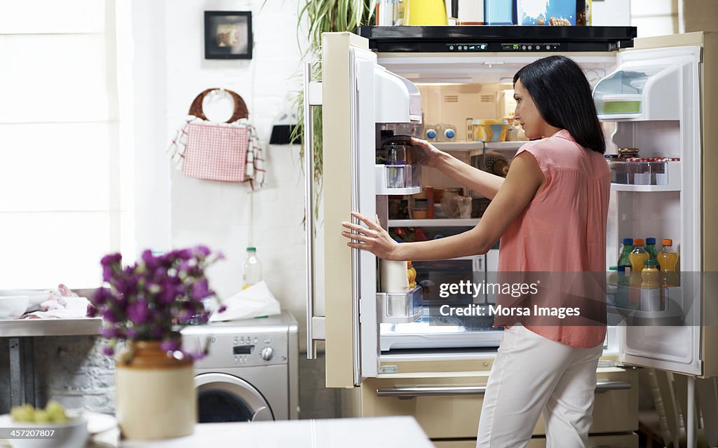 Woman looking in the fridge