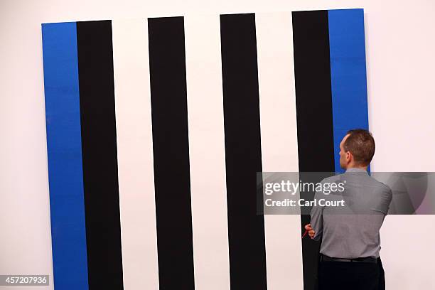 Visitor views an artwork during the VIP and press day at the Frieze Art Fesival on October 14, 2014 in London, England. Due to run from October...