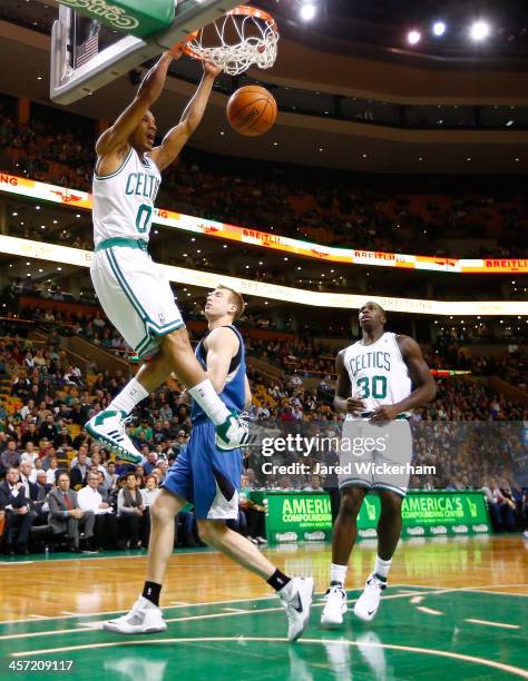 Avery Bradley of the Boston Celtics dunks the ball in front of Robbie Hummel of the Minnesota Timberwolves in the first quarter during the game at TD...