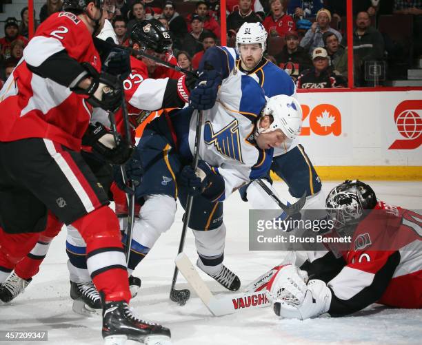 Brenden Morrow of the St. Louis Blues gets hit in front of Robin Lehner of the Ottawa Senators during the first period at the Canadian Tire Centre on...