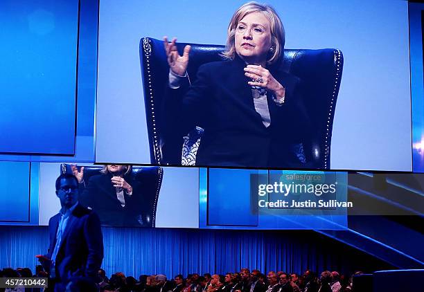 Former U.S. Secretary of State Hillary Clinton is projected on a video screen as she delivers a keynote address during the 2014 DreamForce conference...