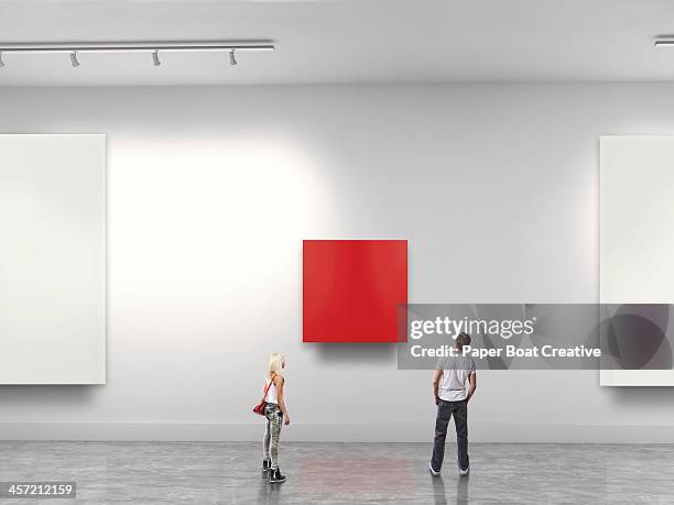 couple looking at red blank art in gallery - exibition fotografías e im�ágenes de stock