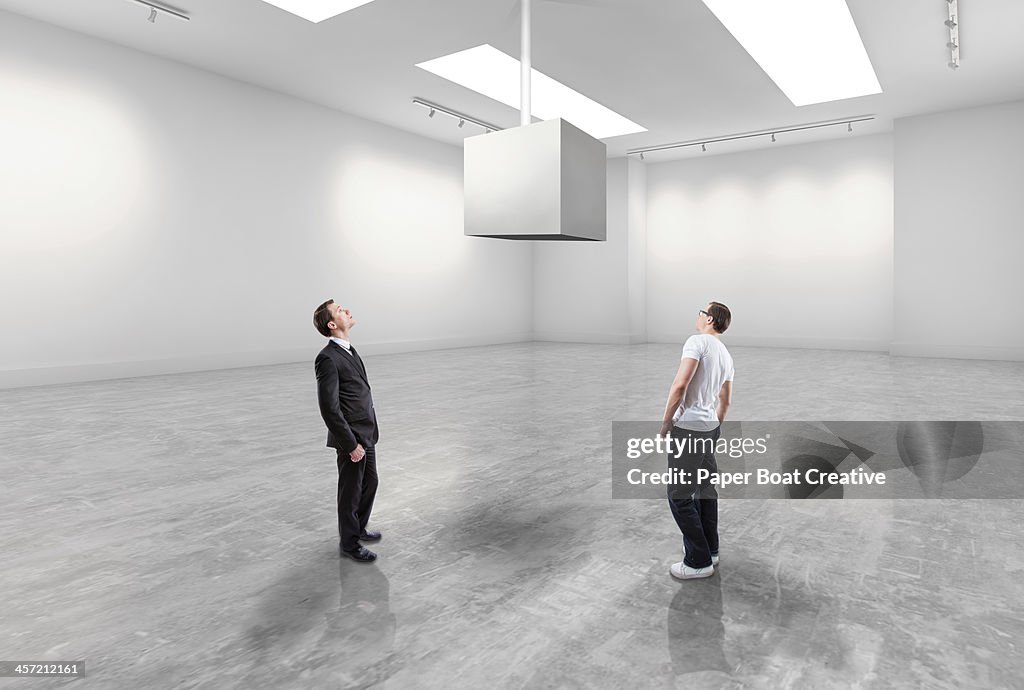 Casual man and business man looking at blank cube