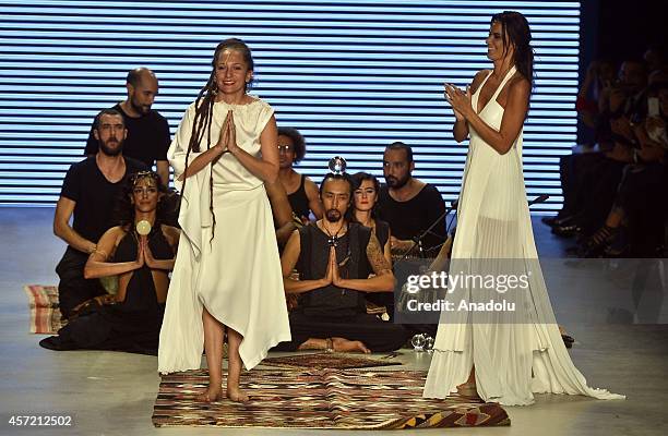 Turkish designer Simay Bulbul greets after models display her creation at the Mercedes-Benz Fashion Week at Antrepo 3 in Istanbul, Turkey on October...