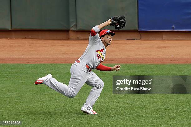 Jon Jay of the St. Louis Cardinals makes a diving catch on a ball hit by Joe Panik of the San Francisco Giants in the first inning during Game Three...
