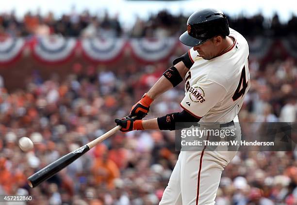 Travis Ishikawa of the San Francisco Giants hits a three RBI double in the first inning against the St. Louis Cardinals during Game Three of the...