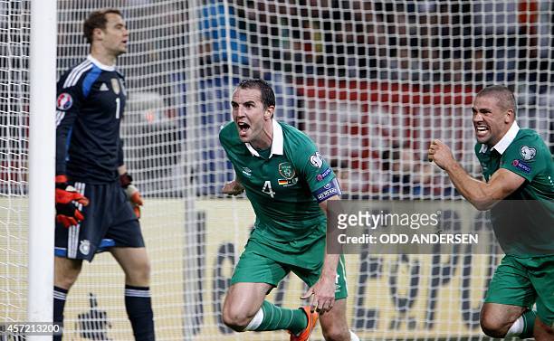 Republic of Ireland's defender John O'Shea reacts after scoring an equalizer during the UEFA Euro 2016 Group D qualifying football match Germany vs...