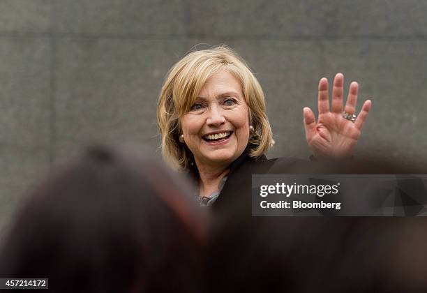 Hillary Clinton, former U.S. Secretary of state, right, waves to attendees during the DreamForce Conference in San Francisco, California, U.S., on...