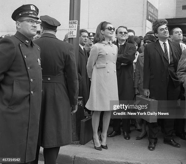 Jacqueline Kennedy stands on tiptoes to watch the St. Patrick's Day parade at 57th Street.