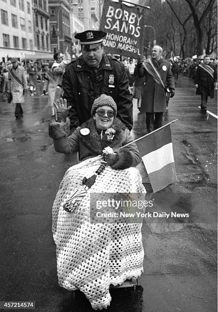 No rain on her parade Geraldine Grahl of Union City, N.J., who won right to "march," is pushed by Sgt. Tom Dunleavy ahead of banner proclaiming late...