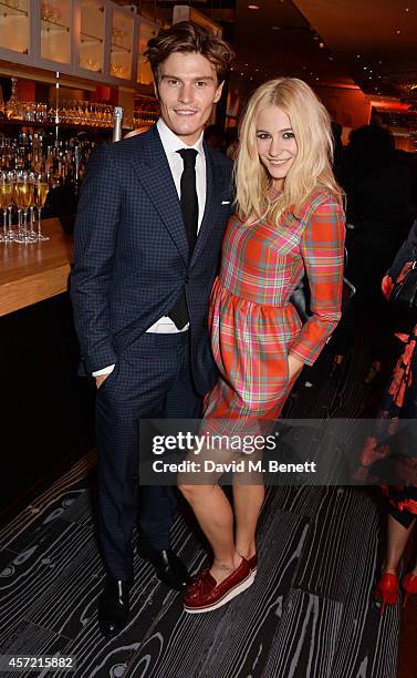 Oliver Cheshire and Pixie Lott attend a party hosted by Jonathan Shalit to celebrate his OBE at Avenue on October 14, 2014 in London, England.