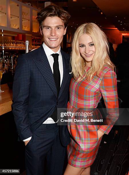 Oliver Cheshire and Pixie Lott attend a party hosted by Jonathan Shalit to celebrate his OBE at Avenue on October 14, 2014 in London, England.