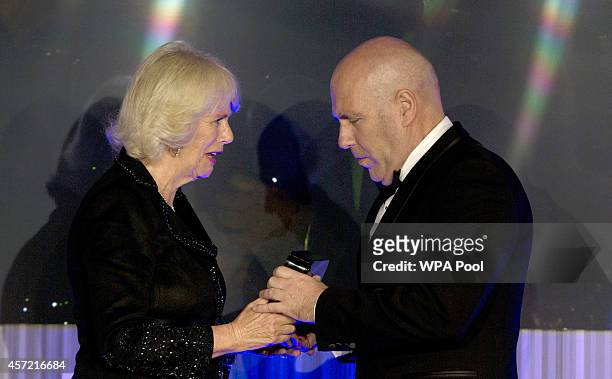Winner of the Man Booker for fiction 2014 Australian, Richard Flanagan author of 'The Narrow Road to the Deep North', is congratulated by Camilla,...