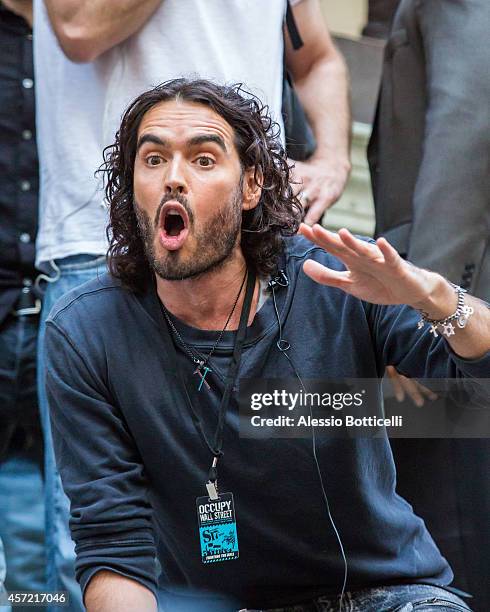 Russell Brand joins the Occupy Wall Street crowd at Zuccotti Park to promote his book 'Revolution' on October 14, 2014 in New York City.