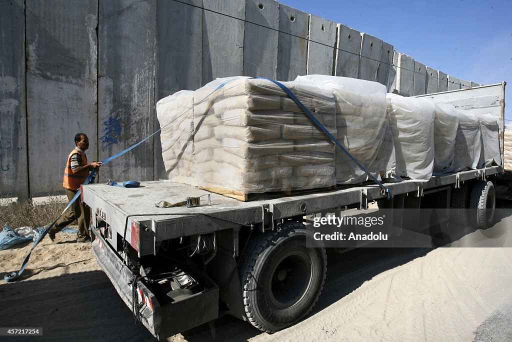 Trucks carrying construction materials cross Karam Abu Salem