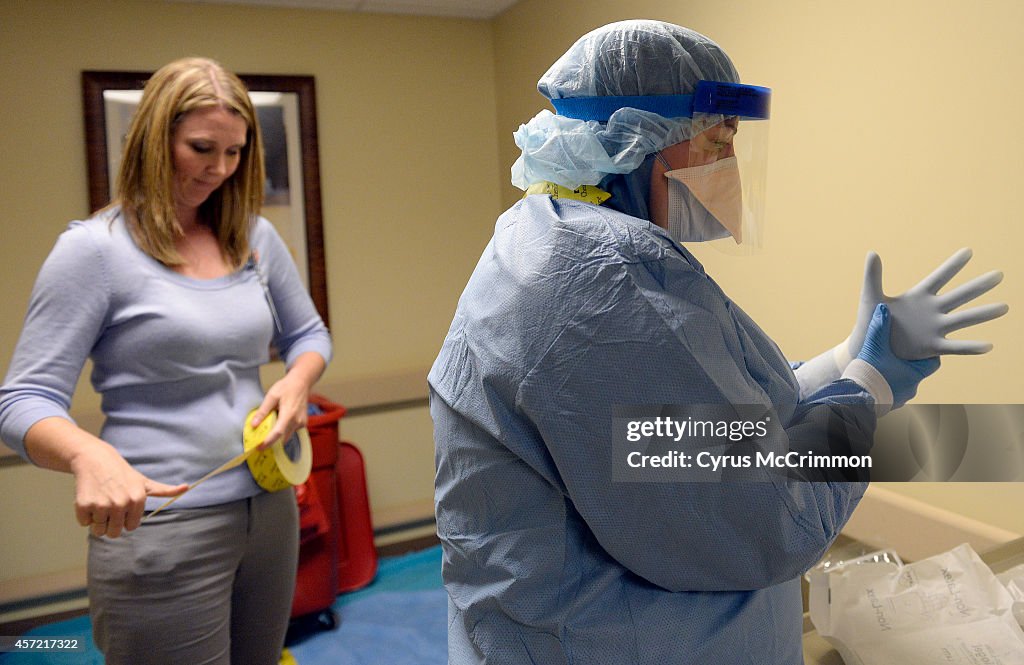The medical staff at Presbyterian/St. Luke's Medical Center are practicing safe procedures for "donning and doffing" of the  medical protection gear in the event they begin treating ebola patients at the Denver hospital