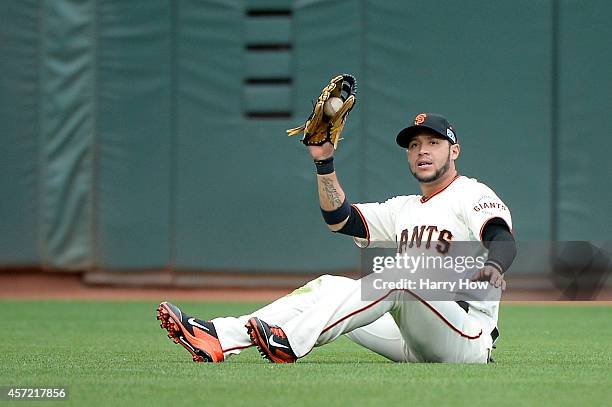 Gregor Blanco of the San Francisco Giants catches a fly ball hit by Matt Adams of the St. Louis Cardinals in the eighth inning during Game Three of...