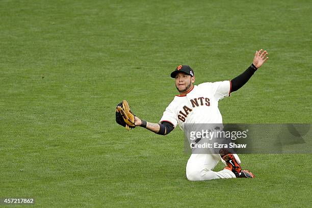 Gregor Blanco of the San Francisco Giants catches a fly ball hit by Matt Adams of the St. Louis Cardinals in the eighth inning during Game Three of...