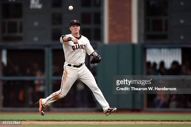 Joe Panik of the San Francisco Giants throws out Matt Carpenter of the St. Louis Cardinals in the eighth inning during Game Three of the National...