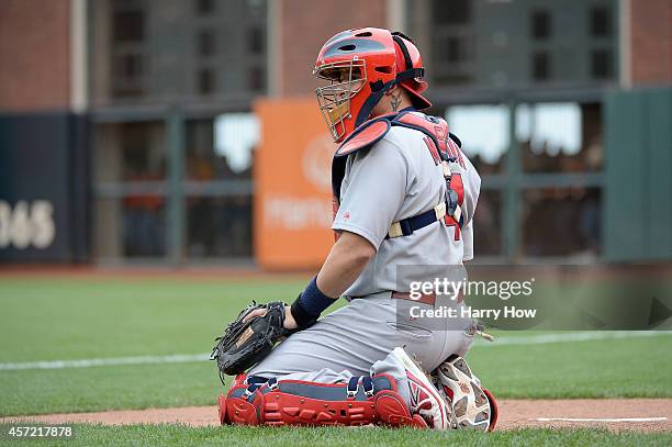 Yadier Molina of the St. Louis Cardinals warms up in the bullpen in the eighth inning while taking on the San Francisco Giants during Game Three of...
