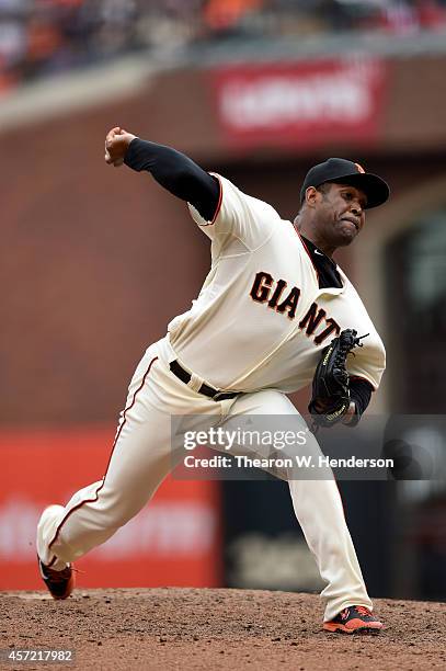 Santiago Casilla of the San Francisco Giants pitches in the ninth inning against the St. Louis Cardinals during Game Three of the National League...