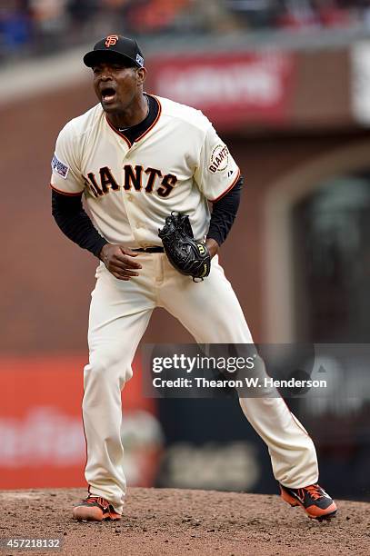 Santiago Casilla of the San Francisco Giants reacts after getting the third out in the ninth inning against the St. Louis Cardinals during Game Three...