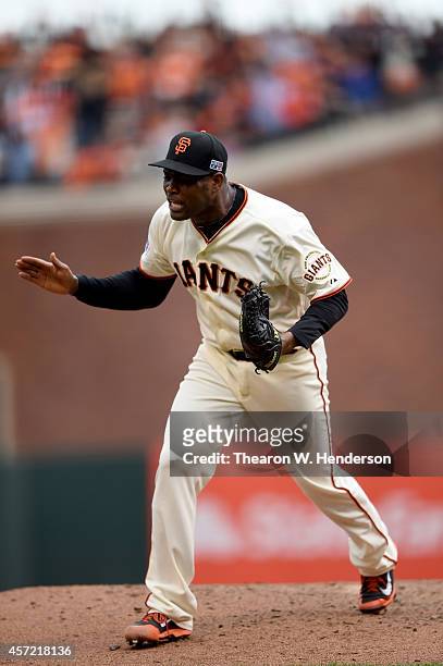 Santiago Casilla of the San Francisco Giants reacts after getting the third out in the ninth inning against the St. Louis Cardinals during Game Three...