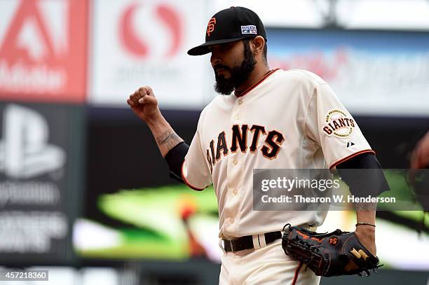 Sergio Romo of the San Francisco Giants reacts after getting the third out in the 10th inning against the St. Louis Cardinals during Game Three of...