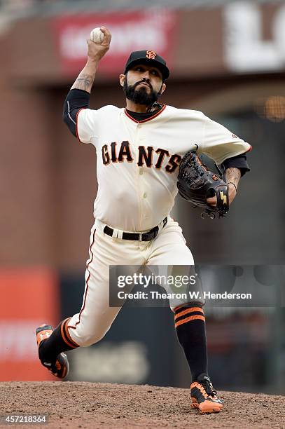 Sergio Romo of the San Francisco Giants pitches in the 10th inning against the St. Louis Cardinals during Game Three of the National League...