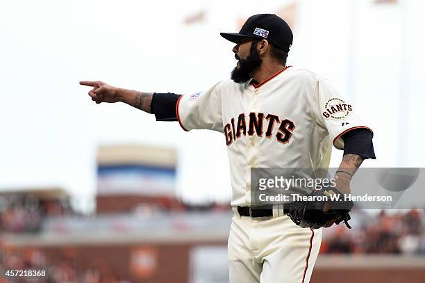 Sergio Romo of the San Francisco Giants reacts after getting the third out in the 10th inning against the St. Louis Cardinals during Game Three of...