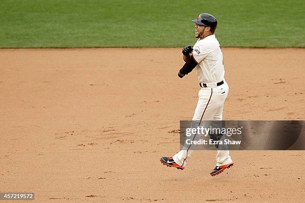 Gregor Blanco of the San Francisco Giants and the Giants celebrate the 10th inning 5-4 victory against the St. Louis Cardinals during Game Three of...