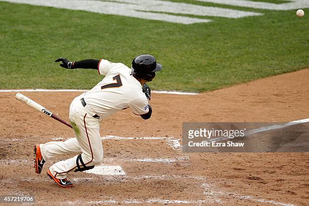 Gregor Blanco of the San Francisco Giants bunts the ball in the 10th inning to pitcher Randy Choate of the St. Louis Cardinals during Game Three of...