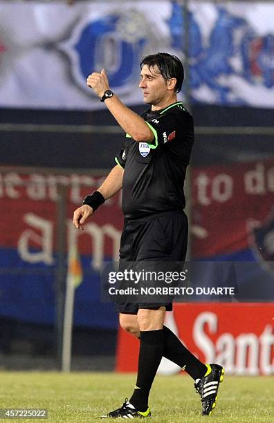 Uruguayan referee Dario Ubriaco gestures during the Copa Sudamericana football match between Paraguay's Cerro Porteno and Argentina's Lanus at the...