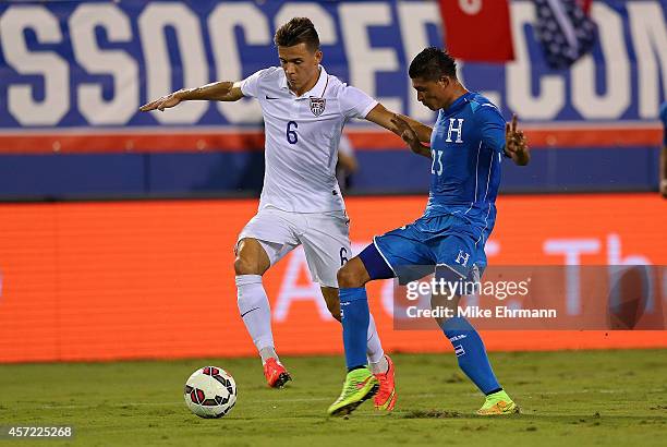 Alfredo Morales of the USA fights for a ball with Edder Delgado of Honduras during a game at FAU Stadium on October 14, 2014 in Boca Raton, Florida.