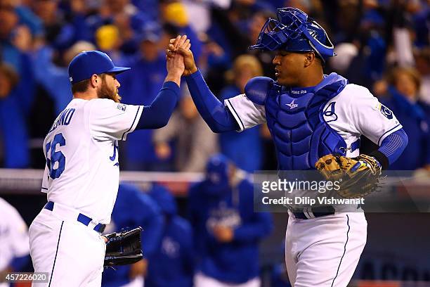 Greg Holland of the Kansas City Royals celebrates with catcher Salvador Perez after closing out the ninth inning to defeat the Baltimore Orioles 2 to...