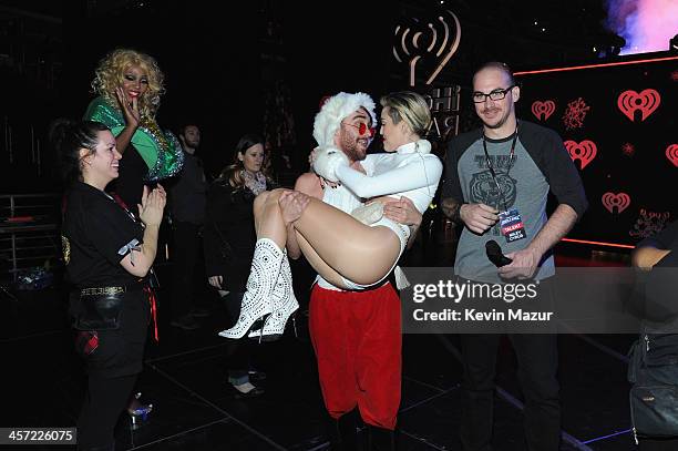 Shane Thomas and Miley Cyrus pose backstage at Hot 99.5s Jingle Ball 2013, presented by Overstock.com, at Verizon Center on December 16, 2013 in...