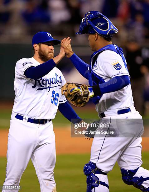 Greg Holland of the Kansas City Royals celebrates with catcher Salvador Perez after closing out the ninth inning to defeat the Baltimore Orioles 2 to...