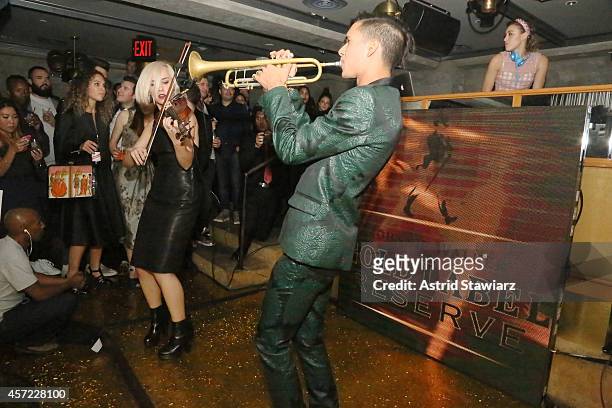 Violinist Margot and DJ Mia Moretti of The Dolls, and trumpeter Spencer Ludwig of Capital Cities perform at Johnnie Walker's toast of the launch of...