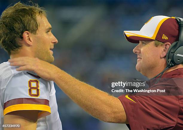 Washington quarterback Kirk Cousins , left, is greeted by head coach Jay Gruden after a late 4th quarter touchdown as the Baltimore Ravens defeat the...